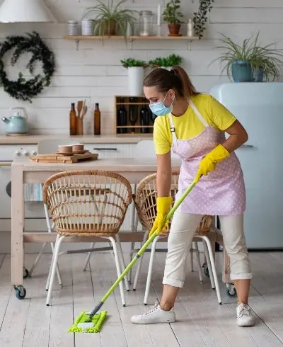 Cleaner polishing a kitchen worktop