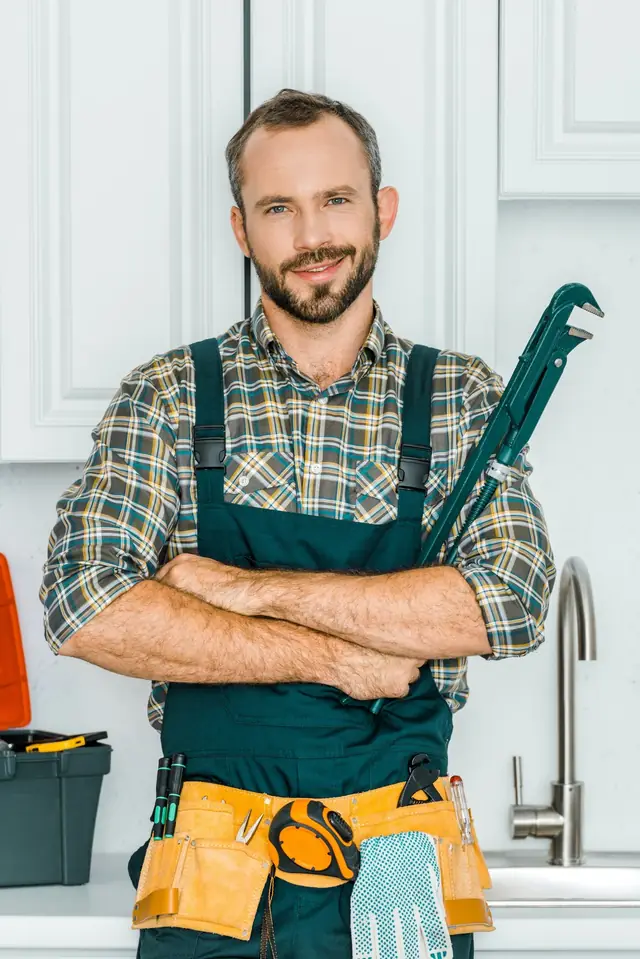 Oleg Vdovin, handyman, holding a wrench in a kitchen in Lagos